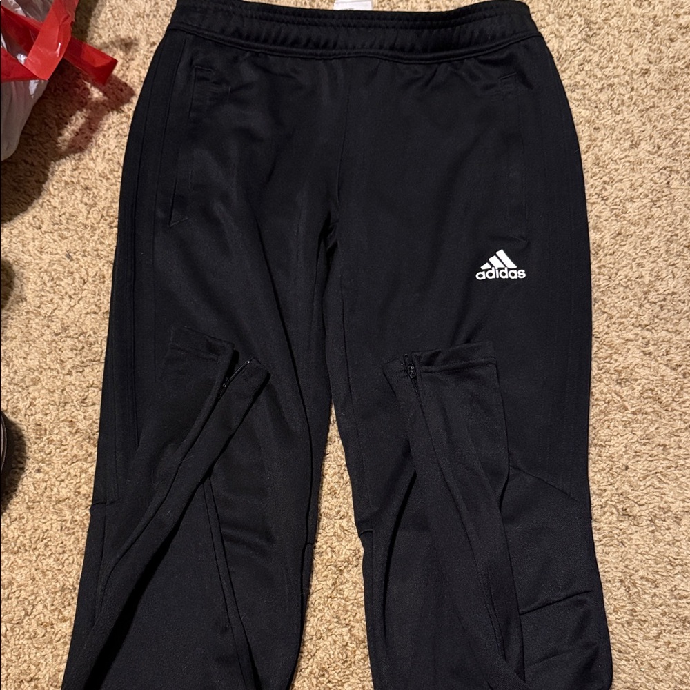 Women’s Adidas lounge pants side zippers on ankle and have pockets